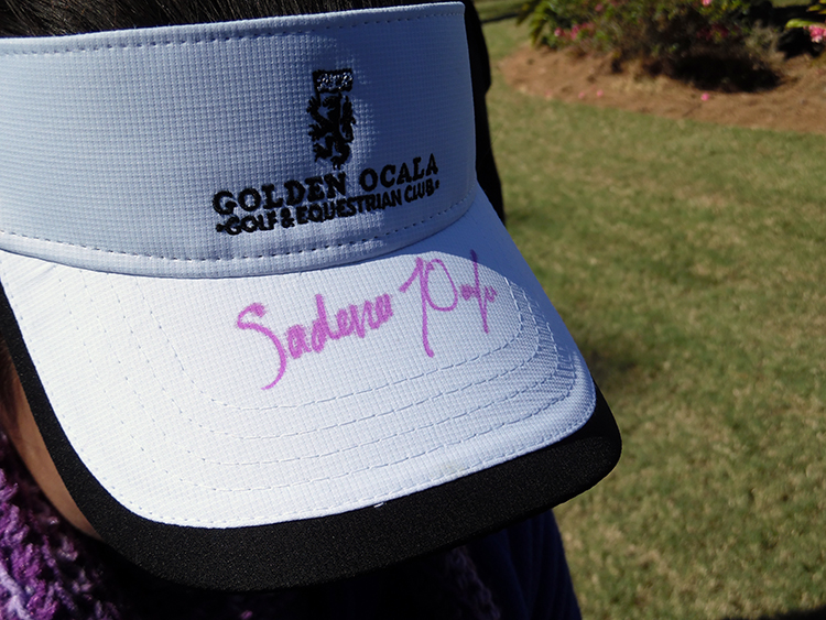 Sadena Parks signed her autograph on a young fan's visor.