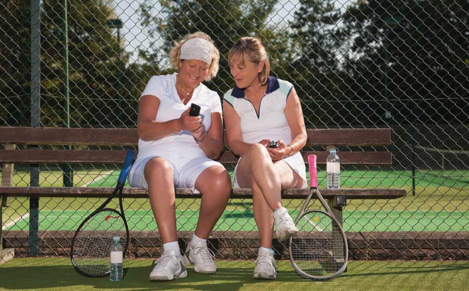 Tennis players checking statistics on a phone.