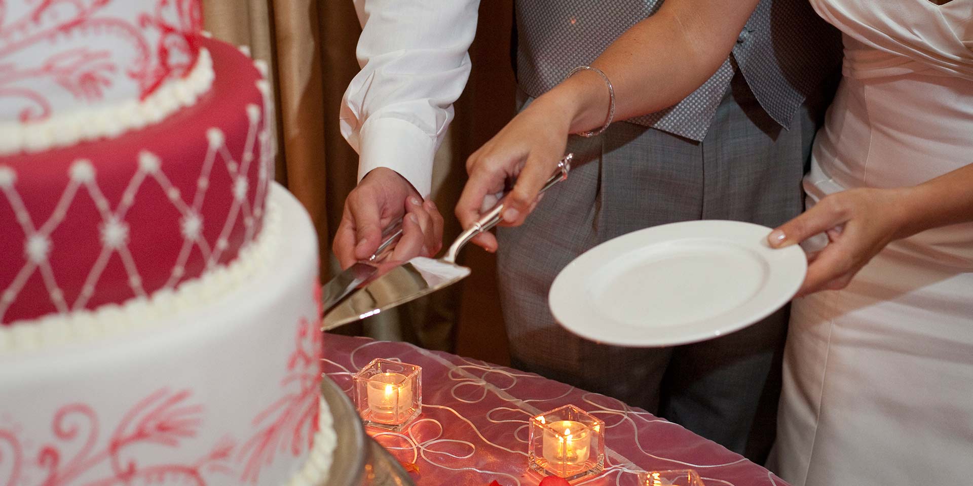 Couple cutting cake at a wedding.